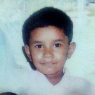 Yusuf at around five years old — a soft, faded photo print.